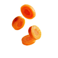 Sliced carrots suspended in air against a black background