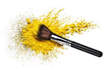 Yellow powder and brush on dark background