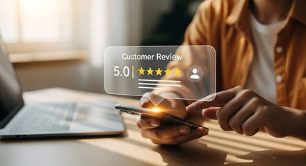 Person using smartphone with customer review overlay showing five stars rating and laptop nearby
