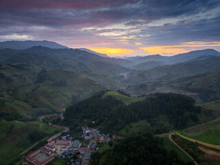 Fototapeta premium Aerial view of golden rice terraces at Mu Cang Chai town near Sapa city, North of Vietnam. Beautiful terraced rice field in harvest season in Yen Bai province.