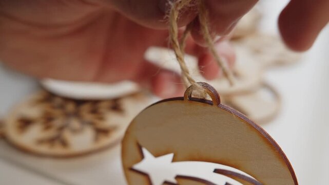 Close-up of laser-cut wooden Christmas ornaments with snowflake and star designs.