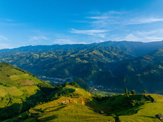 Obraz premium Aerial view of golden rice terraces at Mu Cang Chai town near Sapa city, North of Vietnam. Beautiful terraced rice field in harvest season in Yen Bai province.