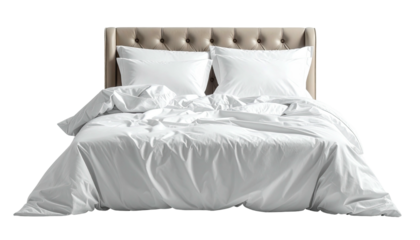 Soft bed with crumpled white linens and tufted headboard