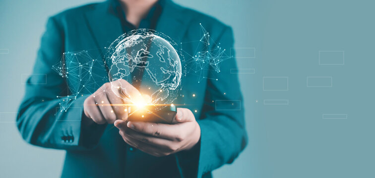 Businessman using smartphone with digital hologram globe, representing global network, innovation, technology, communication, connection, and business growth in the era of digital transformation - Powered by Adobe