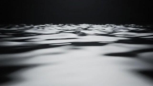 Abstract Liquid Silver Surface - A close-up shot captures a surface of liquid silver material with small, subtle ripples across it.