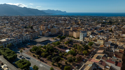 Fototapeta premium Aerial view of the main square of Alcamo, a city located in the province of Trapani, Sicily, Italy. In the background is the Gulf of Castellammare and the Mediterranean Sea.