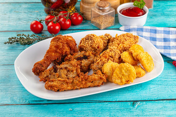 Golden crispy fried chicken mix - wings, drumsticks, nuggets and strips