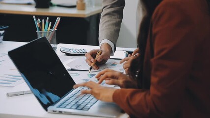 Financial analysts analyze business financial reports on a digital tablet planning investment project during a discussion at a meeting of corporate showing the results of their successful teamwork. - Powered by Adobe