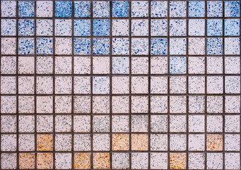 A colorful mosaic pattern made of small square tiles