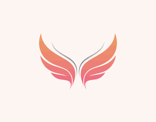 This image features a pair of beautifully designed wings that are colored in a gradient from orange to pink, symbolizing freedom and creativity in brand identity.