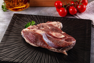 Raw lamb steak with bone