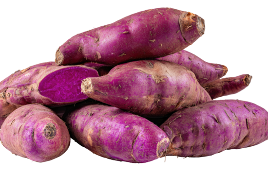 A pile of vibrant purple sweet potatoes, one cut open