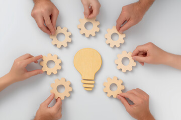 Hands assembling wooden gears around a light bulb shape, symbolizing collaboration and creativity in problem-solving and innovation.