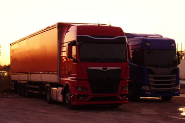 transport, logistics, and trucks. Two trucks parked at sunset.