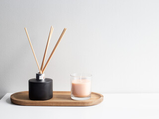 Cozy Home Decor with Candle and Aroma Diffuser. Minimal Interior — Burning Candle and Eucalyptus Vase