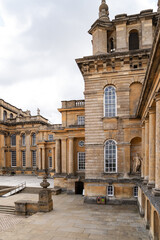 A historic European building with classic baroque architecture, tall arched windows, and stone columns, representing elegant heritage style design.