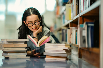 A portrait image conveying the emotion of relaxed reading in a library setting filled with bookshelves. It represents calmness, silence, and the commitment to lifelong learning. © Wanwajee