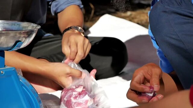 Weighing and packaging beef for Eid al-Adha meat distribution in local community