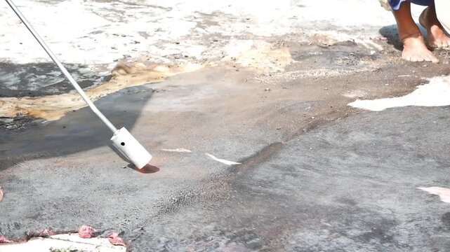 Cleaning and burning cowhide using fire during Eid al-Adha preparation in Indonesia
