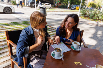Tourists enjoying outdoor coffee on a city terrace