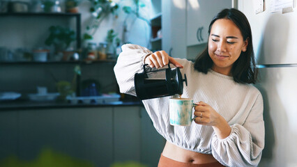 Woman, french press and coffee in kitchen, home and pride with warm beverage, mug and smile....