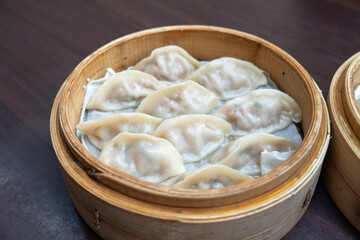 Steamed dumplings in bamboo steamer.