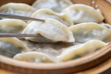 Steamed dumplings in bamboo steamer.