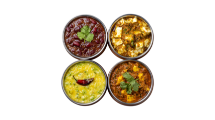 A top down view of four authentic Indian vegetarian meals featuring paneer dal and kidney beans