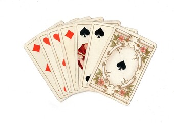Obraz premium A hand of vintage playing cards isolated on a white background.