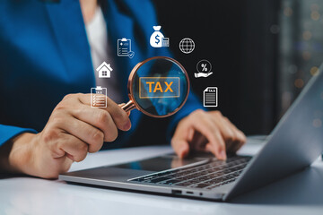 Tax calculator income concept with businessman analyzing tax icon through magnifying glass on...