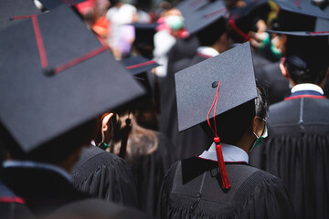 A group of people wearing black graduation gowns and caps