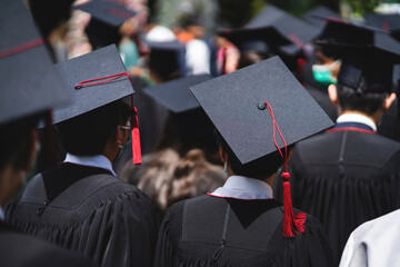 A group of people wearing black graduation gowns and caps