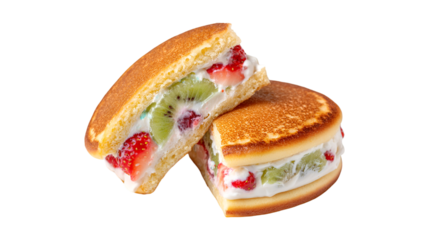 A Japanese pancake sandwich is cut in half revealing a sweet filling of fresh cream strawberries and kiwi on a plain white background
