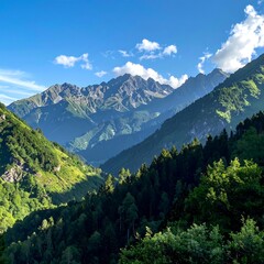 Sunny mountain range with lush green valleys and a blue sky