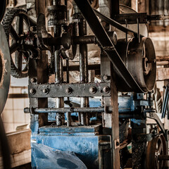 Close Up of  Restored 1920s Rock Crushing Machine with Leather Belt Drive in a Stamping Mill