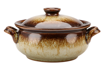 Rustic ceramic casserole dish with lid and handles isolated on black background