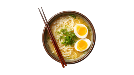 A delicious bowl of Japanese ramen noodle soup with soft boiled eggs and fresh green onions viewed from above with chopsticks resting on the side