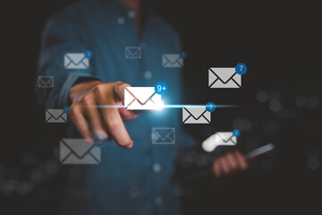 A person using a digital tablet with email icons and message notifications, representing online...