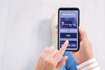 Online payment. Woman using banking app on smartphone indoors, closeup