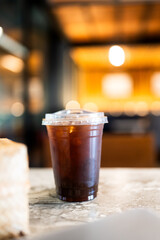 A glass of iced Americano in nice and warm cafe