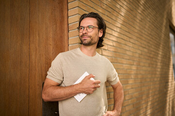 Portrait of confident man with glasses planning outdoors in urban setting