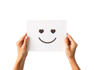 Hands holding white paper with smiley face featuring heart-shaped eyes and happy smile, isolated on a transparent background