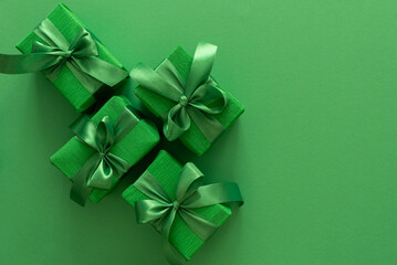 Green Gift Boxes on Solid Green Background with Copy Space
