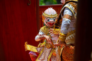 A child performer wearing a Hanuman mask in a traditional Thai Khon dance. The costume is decorated with gold embroidery, showing the beauty of Thailand's classical performing arts.