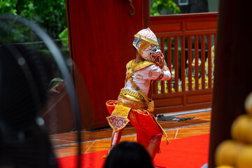 A child performer wearing a Hanuman mask in a traditional Thai Khon dance. The costume is decorated with gold embroidery, showing the beauty of Thailand's classical performing arts.