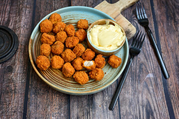Crispy  deep fried   chicken  popcorn  nuggets and french fries . Breaded  with Cornflakes chicken  Breast fillets  with chilly peppers and fresh   basil on wooden rustic background