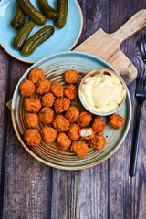 Crispy  deep fried   chicken  popcorn  nuggets and french fries . Breaded  with Cornflakes chicken  Breast fillets  with chilly peppers and fresh   basil on wooden rustic background