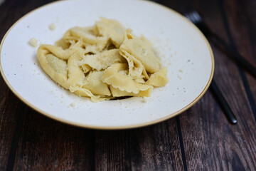 Home made Italian mushroom   Tortelloni  with  parmesan cheese filled with   Mushroom mozzarella cheese, decorated with fresh basil