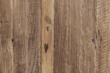 Close-up of rustic wooden planks with natural grain, knots, and weathered texture in vertical layout.