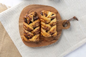 Chocolate braided pastry dessert on wooden board